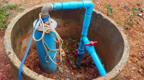 Concrete dry well with exposed pipes