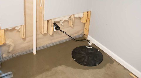 Sump pump in corner of a basement