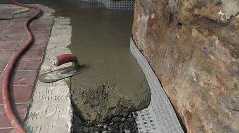 Wet concrete laid over new drain installation