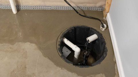 Water surrounding broken sump pump in basement