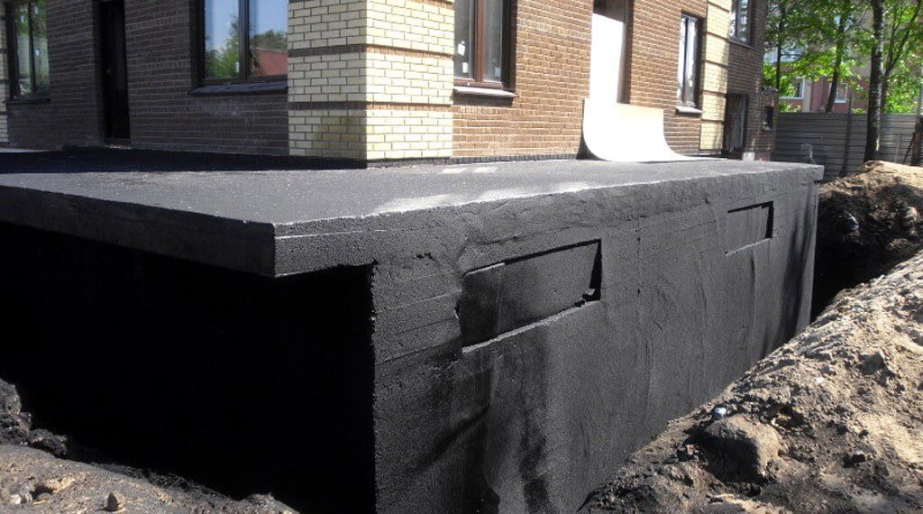 Newly completed exterior waterproofing on home in sun