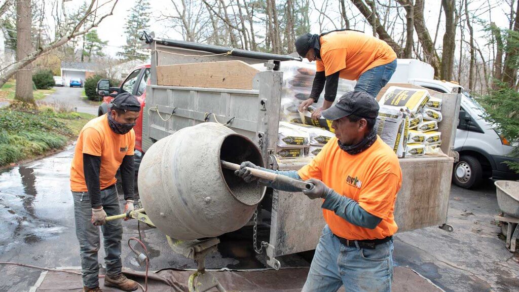Team from Dry Tech Waterproofing Solutions mixing concrete