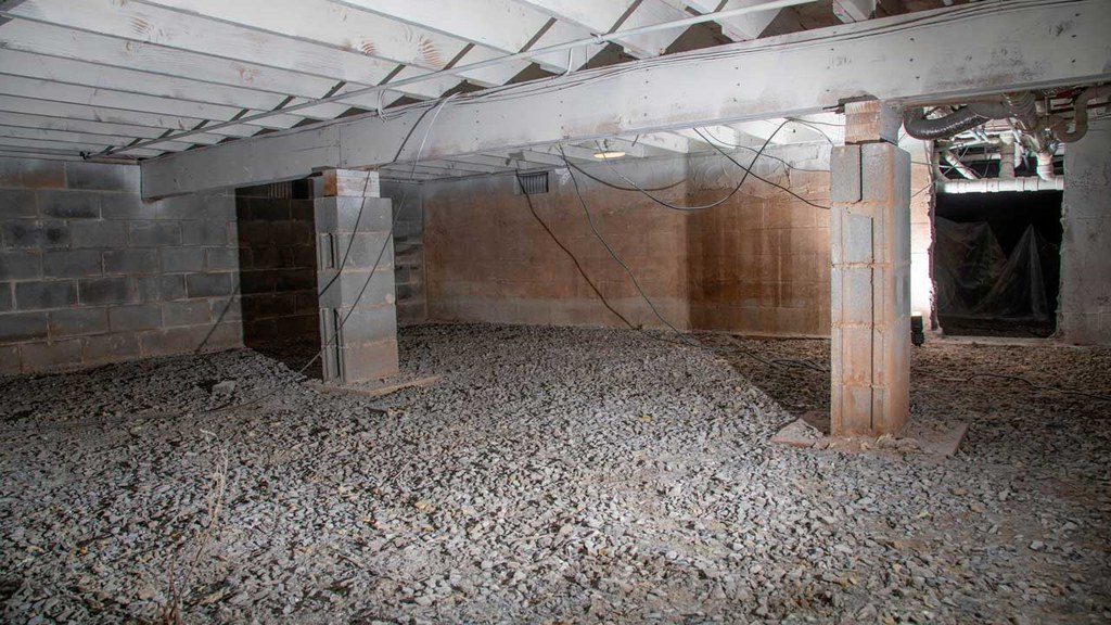 Crawl space in basement prior to insulation