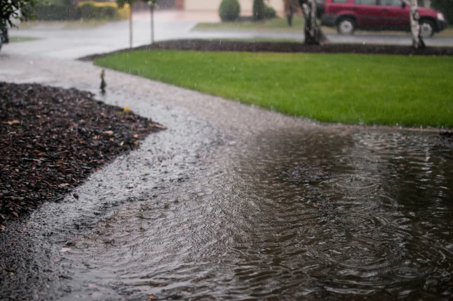 Heavy rain causing flooding outside home