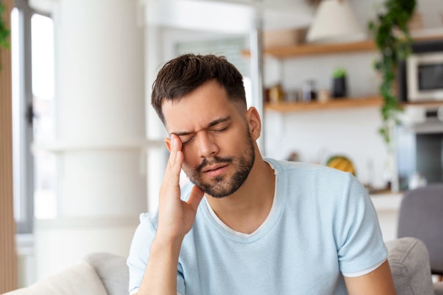 Homeowner experiencing headache symptoms due to overexposure to white mold