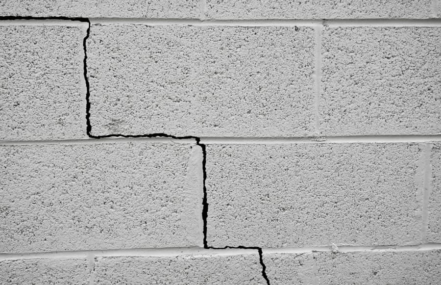 Grey brick foundation with crack